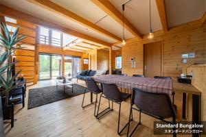 a dining room and living room with a table and chairs at Rusutsu Hills CENTRO in Rusutsu