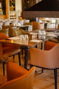 a restaurant with tables and chairs with glasses on them at Hotel U Catagnu in San-Nicolao