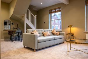 a living room with a couch and a table at The Links Apartments in Newark-on-Trent