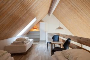 a bedroom with a bed and a table and chairs at Skagen Strand Holiday Center in Hulsig +125 photos
