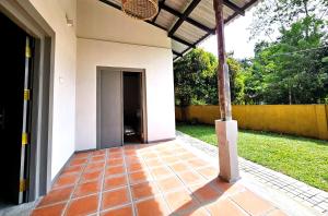 an entrance to a house with a tile floor at Gate House Mirissa in Mirissa