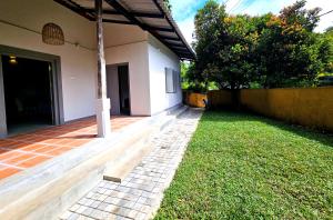 a backyard of a house with a brick walkway at Gate House Mirissa in Mirissa