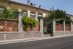 a building with a fence on the side of a street at Bresbot B&B in Bressana Bottarone