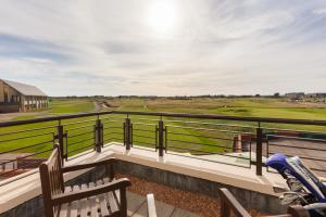 a balcony with a view of a golf course at Carnoustie Golf Hotel 'A Bespoke Hotel’ in Carnoustie