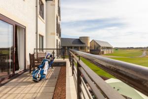a balcony with a view of a golf course at Carnoustie Golf Hotel 'A Bespoke Hotel’ in Carnoustie