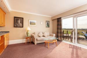 a living room with a couch and a table at Carnoustie Golf Hotel 'A Bespoke Hotel’ in Carnoustie