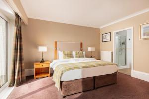 a bedroom with a large bed and a window at Carnoustie Golf Hotel 'A Bespoke Hotel’ in Carnoustie +53 photos