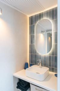 a bathroom with a sink and a mirror at Petit Emba in La Ciotat +7 photos