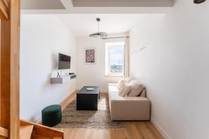 a living room with a couch and a table at Petit Emba in La Ciotat