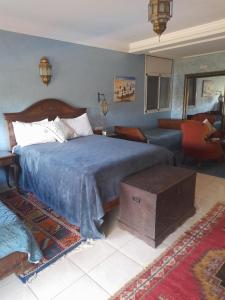 a bedroom with a bed and a living room at Riad TANJIL in Casablanca +63 photos
