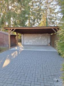 a garage with a wooden cover on top of it at Stadt Land Ferienhaus in Falkensee