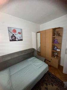 a small bedroom with a bed and a cabinet at SS Stan in Pale
