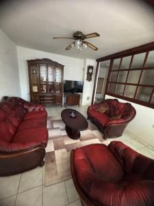 a living room with couches and a ceiling fan at SS Stan in Pale