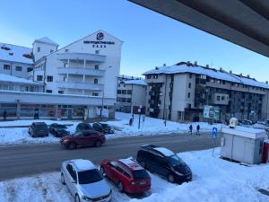 a parking lot with cars parked in the snow at SS Stan in Pale