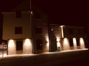 a building with lights on the side of it at night at Apartlogie in Tongeren