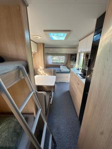 an rv with a kitchen and a sink and a stove at הקרוואן במושב בורגתה in Burgeta