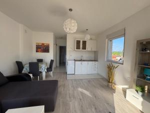 a living room and kitchen with a couch and a table at Vila Amante in Gornja Toplica