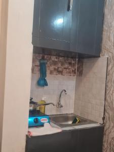 a kitchen counter with a sink and a sink at MAGLO bnb in Nakuru