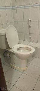 a bathroom with a white toilet in a room at MAGLO bnb in Nakuru