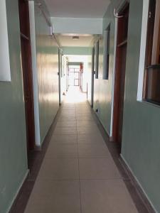 a hallway of an office building with a tile floor at MAGLO bnb in Nakuru
