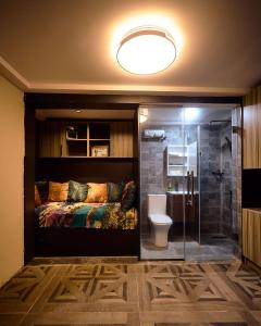 a bedroom with a bed and a shower and a toilet at Premier Cabins in North Legon +95 photos