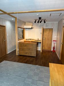 an empty room with a kitchen with a counter top at YADOKARI miyakojima in Miyako-jima