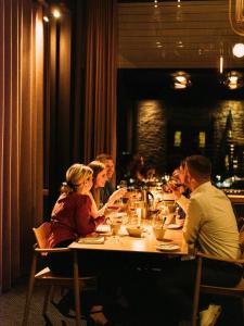 a group of people sitting at a table in a restaurant at Hotel Føroyar in Tórshavn