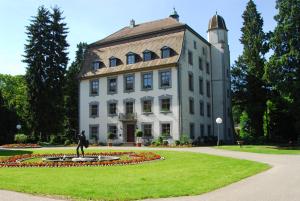 a man standing in front of a large building at Hotel Zum Schwarzen Walfisch in Bad Säckingen