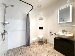 a white bathroom with a sink and a toilet at Moderne Studio Wohnung in Stuttgart-Zentrum in Stuttgart