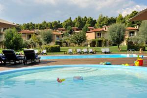 a large swimming pool with a toy in the water at Sani Polyastron Hotel & Spa in Sani Beach