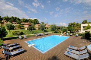 an image of a swimming pool with chaise lounge chairs and a swimming pool at Sani Polyastron Hotel & Spa in Sani Beach