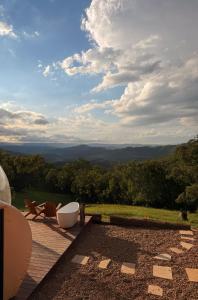 a patio with a tub and a view of the mountains at Romantic Stargazing Getaway - Beyond Bubbles in Kanimbla