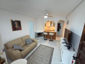 a living room with a couch and a table at Flamingo Apartman in Torrevieja