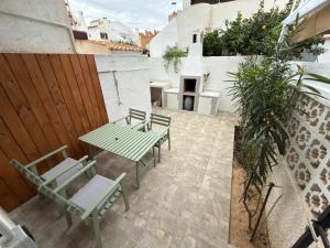a patio with a table and chairs and a fireplace at Flamingo Apartman in Torrevieja