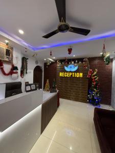 a reception area with a christmas tree and a reception counter at Sportsman beach hotel in Calangute +42 photos