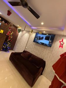 a bedroom with a bed and a tv on a wall at Sportsman beach hotel in Calangute