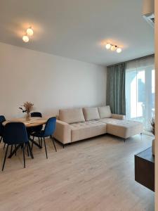 a living room with a couch and a table at SzemesBay Apartment by BLTN in Balatonszemes