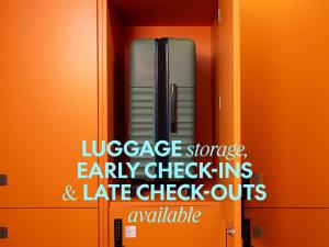 an orange wall with a sign that saysuggage storage and early checkins and late at Bob W Rome Testaccio in Rome