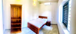 a small bedroom with a bed and a window at Gate House Mirissa in Mirissa +9 photos