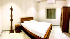 a bedroom with a large bed in a room at Gate House Mirissa in Mirissa