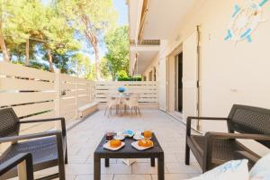 a patio with chairs and a table with food on it at Crystal Camere in Marcelli