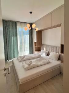 a bedroom with two beds and a large window at SzemesBay Apartment by BLTN in Balatonszemes +28 photos