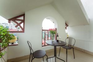 a table and chairs in a room with a window at Hanoi Spoon Boutique Hotel in Hanoi