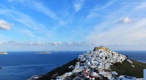 a group of white buildings on an island in the ocean at Catsalos Studios in Pera Gyalos