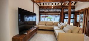 a living room with a couch and a flat screen tv at 전주한옥마을 자하연해랑 in Jeonju