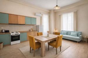 a kitchen and living room with a table and a couch at Aurora Apartments in Mytilene