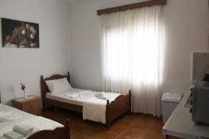 a small bedroom with a bed and a window at Diar Sea House in Orikum