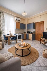 a living room with a couch and a table at Aurora Apartments in Mytilene