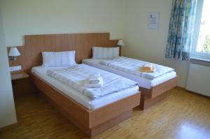 Postel nebo postele na pokoji v ubytování Das Gästehaus Puschendorf