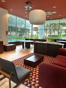 a living room with a couch and chairs and a table at Oxley Thanksgiving Residence in Singapore
